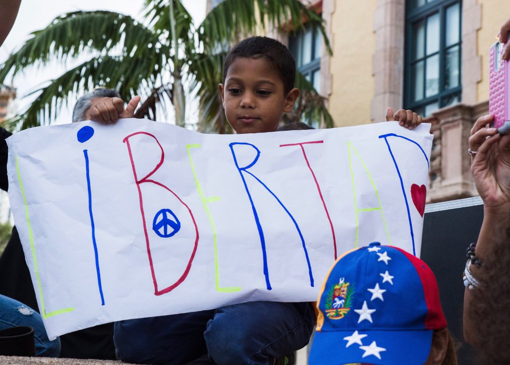 Little boy holding a sign.