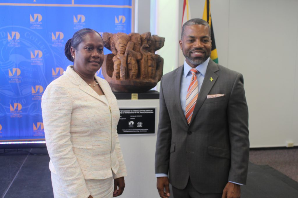 North Campus President Malou C. Harrison and Consulate General of Jamaica Franz Hall posing in front of the sculpture.