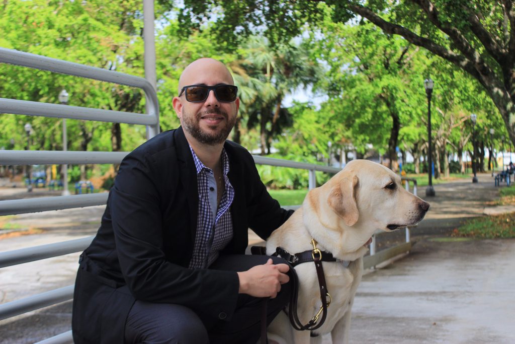 Gabriel Lopez Kafati with his guide dog, Posh at MDC North Campus.