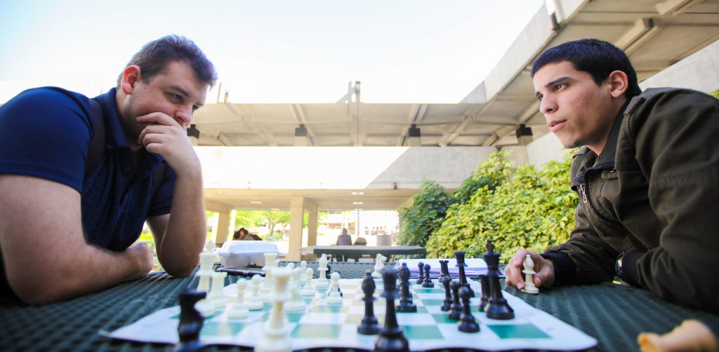 Students Gabriel Custodio and Brian Torres playing chess.