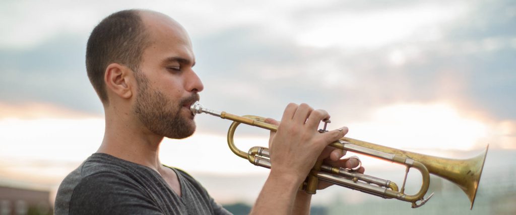 Photo of Amir ElSaffer playing the trumpet.