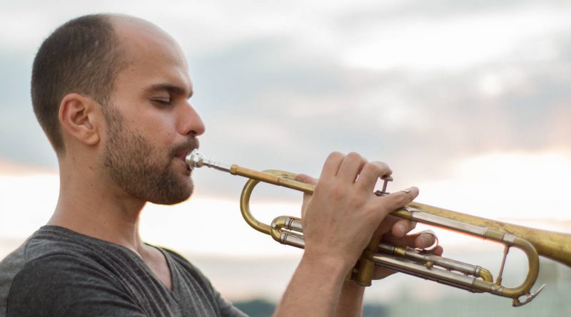 Photo of Amir ElSaffer playing the trumpet.