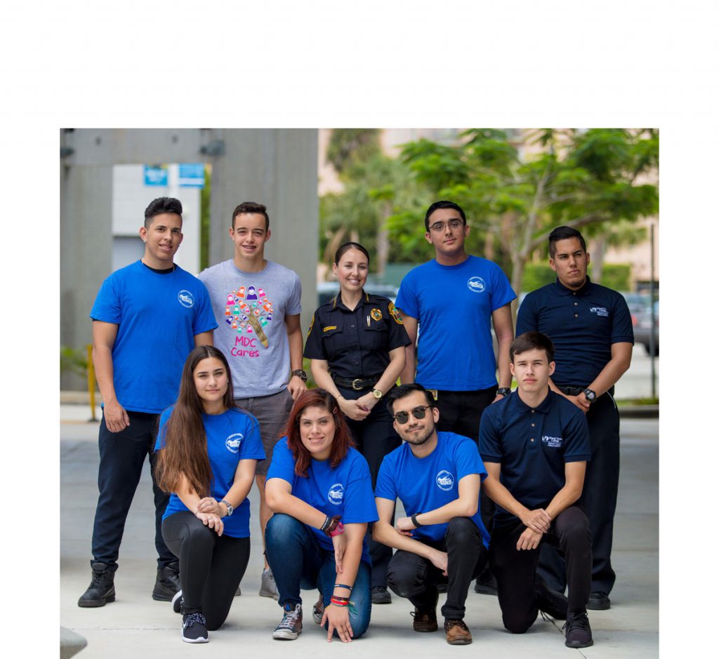 Shark Patrol students posing with Hialeah public safety chief Stephanie Fernandez.