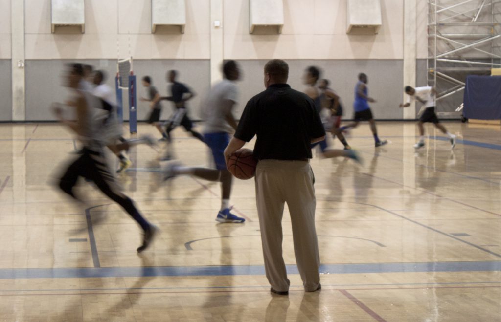 Coach looking at players during tryouts.