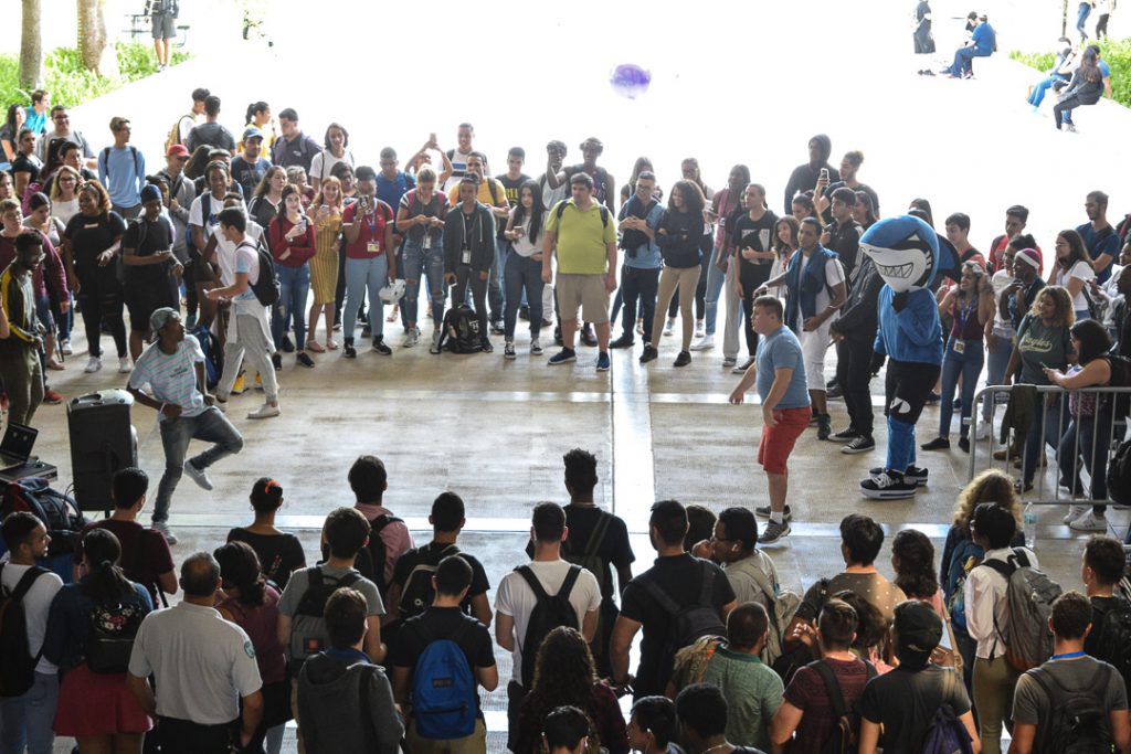 Students watching on as others dance.