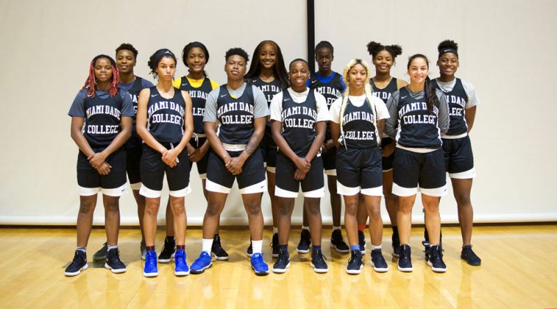 The Lady Sharks basketball team posing for the camera.