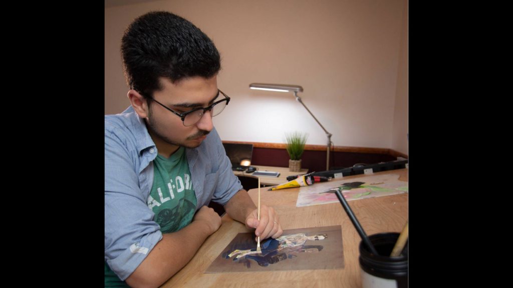 Brito painting in his room.