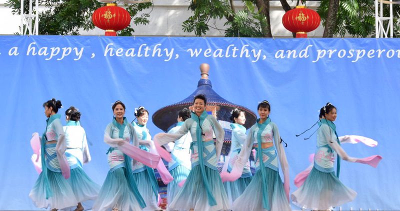 Members of the Chinese Cultural Foundation performing on stage.