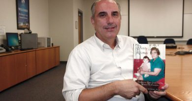 Shawn Schwaner posing with his book.