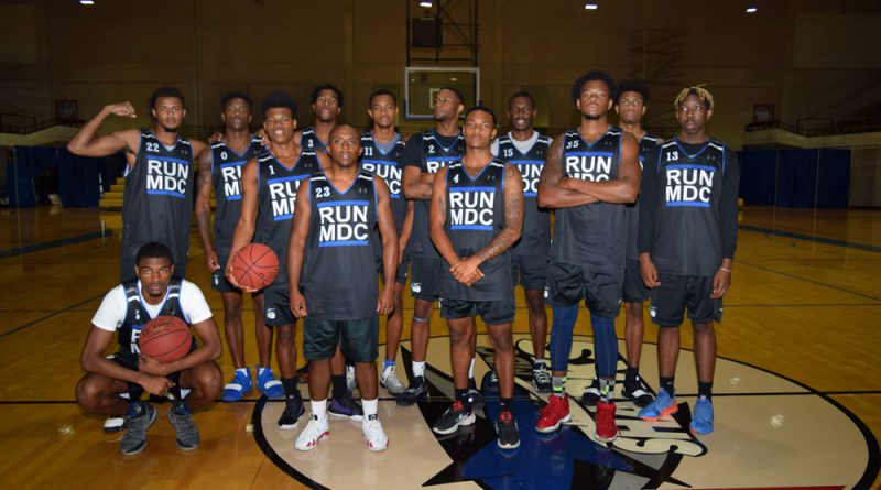 Men's basketball team posing for the camera.