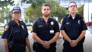 Three public officers posing for the camera.