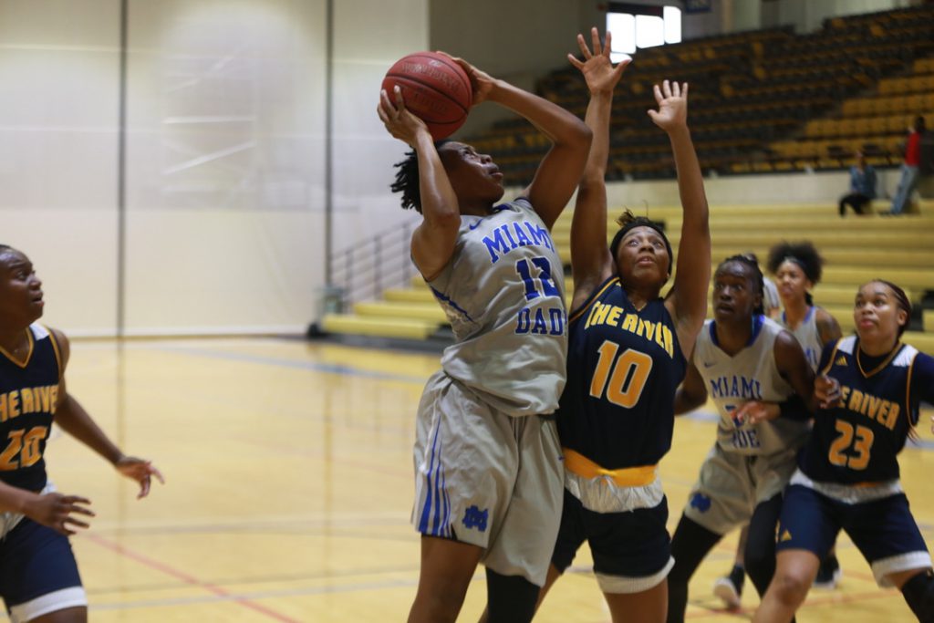 Daliyah Brown trying to score a basketball.