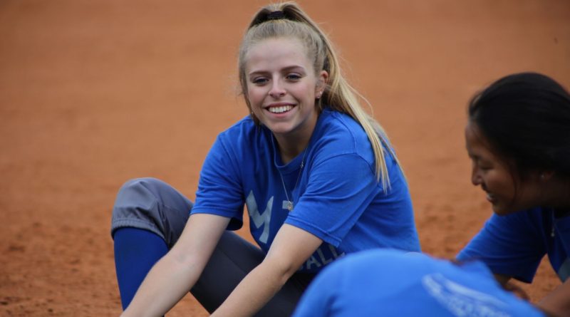 Amber Dalfonso laughing with her teammates.