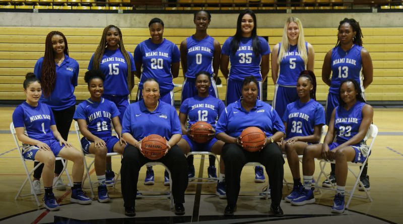 Lady Sharks basketball team posing for the camera.