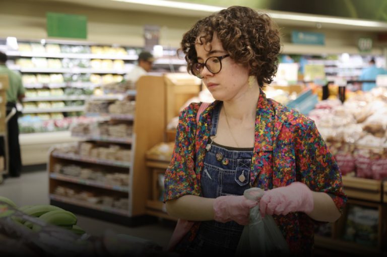 Isabella Garcia picking groceries as part of the Buddy System.