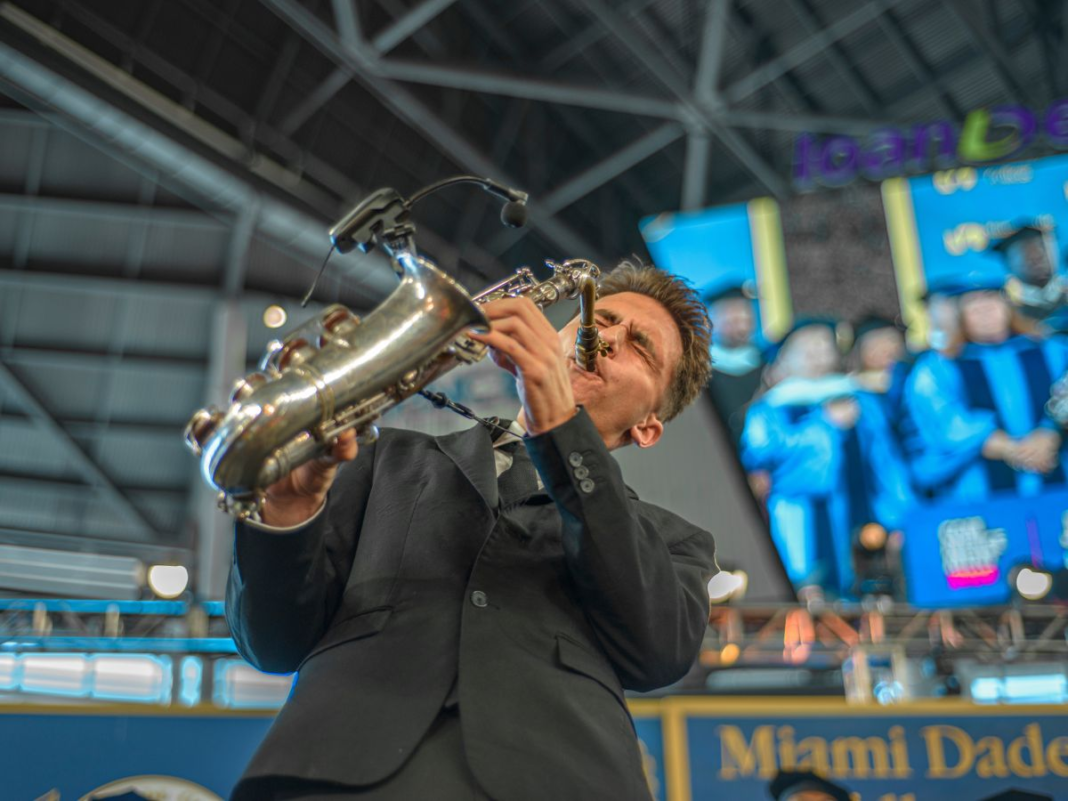 Jazz At LoanDepot: Grammy Award winner and presidential scholar Joey Calveiro performs the Star-Spangled Banner on his saxophone at the North, Hialeah and West campuses commencement on April 25. LUCAS DUARTE/THE REPORTER