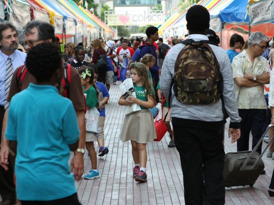 A kid clutches her book at Miami Book Fair in a Reporter archive photo.